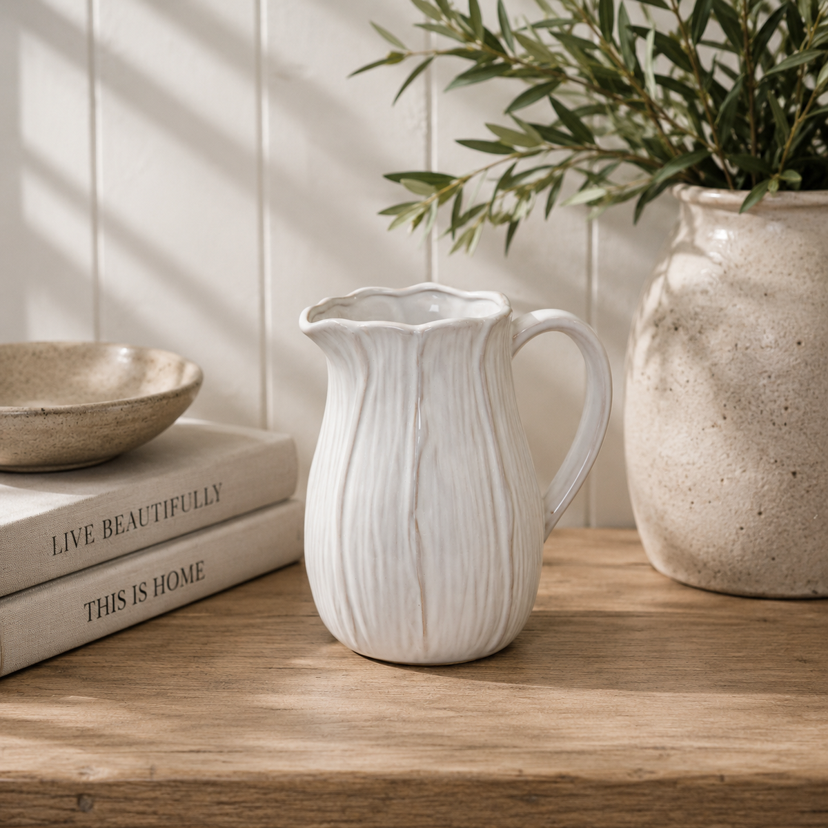 Natural ceramic jug with petal shape design detail